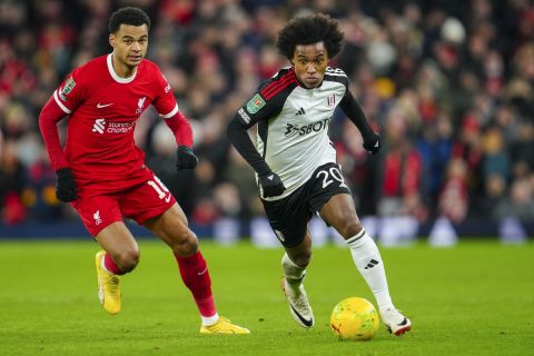 Fulham's Willian, right, duels for the ball with Liverpool's Cody Gakpo during the EFL Cup first leg semi final soccer match between Liverpool and Fulham at Anfield stadium in Liverpool, England, Wednesday, Jan. 10, 2024. (AP Photo/Jon Super)