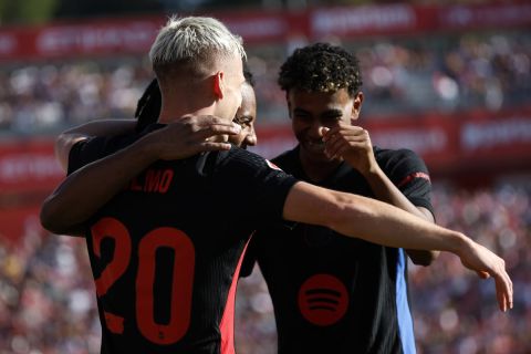 Barcelona's Dani Olmo, left, celebrates with his teammates after scoring his side's third goal during the Spanish La Liga soccer match between Girona and Barcelona at the Montilivi stadium in Girona, Spain, Sunday, Sept. 15, 2024. (AP Photo/Joan Monfort)