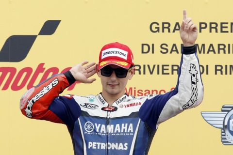 Yamaha MotoGP rider Jorge Lorenzo of Spain gestures as he celebrates on the podium after winning the San Marino motorcycling Grand Prix at the Misano circuit September 4, 2011.  REUTERS/Giampiero Sposito (ITALY - Tags: SPORT MOTORSPORT)