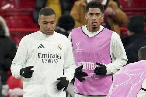 Real Madrid's Kylian Mbappe and Jude Bellingham, from left, exercise during warmup before the Champions League opening phase soccer match between Liverpool and Real Madrid at Anfield Stadium, Liverpool, England, Wednesday, Nov. 27, 2024. (AP Photo/Jon Super)