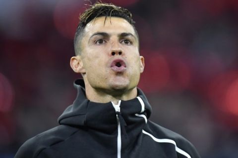 Juventus' Cristiano Ronaldo stands for the the Champions League anthem ahead of the Champions League quarterfinal, first leg, soccer match between Ajax and Juventus at the Johan Cruyff ArenA in Amsterdam, Netherlands, Wednesday, April 10, 2019. (AP Photo/Martin Meissner)