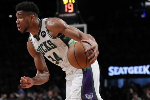 Milwaukee Bucks forward Giannis Antetokounmpo (34) drives to the basket against the Brooklyn Nets during the first half of an NBA basketball game, Thursday, March 31, 2022 in New York. (AP Photo/Noah K. Murray)