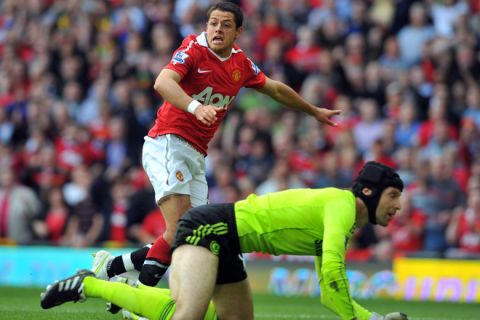 Manchester United's Mexican forward Javier Hernandez (up) watches as his shot go past Chelsea's Czech goalkeeper Petr Cech to score during the English Premier League football match between Manchester United and Chelsea at Old Trafford in Manchester, north west England, on May 8, 2011. AFP PHOTO/ANDREW YATES - FOR EDITORIAL USE ONLY Additional licence required for any commercial/promotional use or use on TV or internet (except identical online version of newspaper) of Premier League/Football League photos. Tel DataCo +44 207 2981656. Do not alter/modify photo. (Photo credit should read ANDREW YATES/AFP/Getty Images)