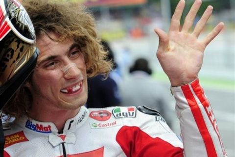 Italian MotoGP driver Marco Simoncelli celebrates after clocking the fastest time to claim pole position after timed practice at Montmelo racetrack near Barcelona, Spain, Saturday, June 4, 2011 before Sunday's Spanish Motorcycle Grand Prix. (AP Photo/Manu Fernandez)