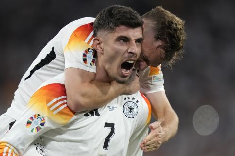 Germany's Kai Havertz celebrates with Joshua Kimmich after scoring his side's third goal during a Group A match between Germany and Scotland at the Euro 2024 soccer tournament in Munich, Germany, Friday, June 14, 2024. (AP Photo/Matthias Schrader)