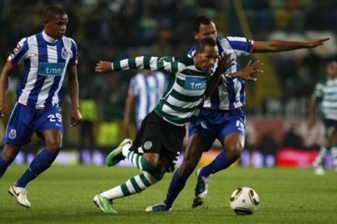 Sporting's Liedson, center, vies for the ball with Porto's Rolando Pires, from Cape Verde, right, and Fernando Reges, from Brazil, during their Portuguese League soccer match on Saturday, Nov. 27, 2010 at Sporting's Alvalade stadium in Lisbon (AP Photo/ Francisco Seco)