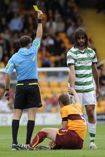 Celtic's Georgios Samaras (R) is booked by referee Dougie McDonald after his challenge on Motherwell's Stephen Craigan (C) during their Scottish Premier League soccer match at Fir Park in Motherwell, Scotland, August 29, 2010. REUTERS/Russell Cheyne (BRITAIN - Tags: SPORT SOCCER)