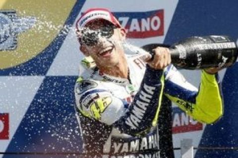 Yamaha rider Valentino Rossi, of Italy, celebrates on the podium after winning   the San Marino MotoGP at the Misano circuit , in Misano, Italy, Sunday, Sept. 6, 2009. (AP Photo/Antonio Calanni)