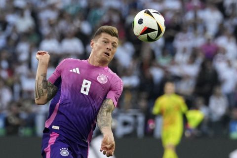 Germany's Toni Kroos jumps for the ball during the international friendly soccer match between Germany and Greece at the Borussia Park in Moenchengladbach, Germany, Friday, June 7, 20204. (AP Photo/Martin Meissner)