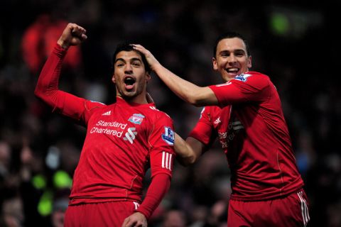 NORWICH, ENGLAND - APRIL 28:  (L-R) Luis Suarez of Liverpool is congratulated by teammate Stewart Downing after scoring his team's thord goal during the Barclays Premier League match between Norwich City and Liverpool at Carrow Road on April 28, 2012 in Norwich, England.  (Photo by Jamie McDonald/Getty Images)