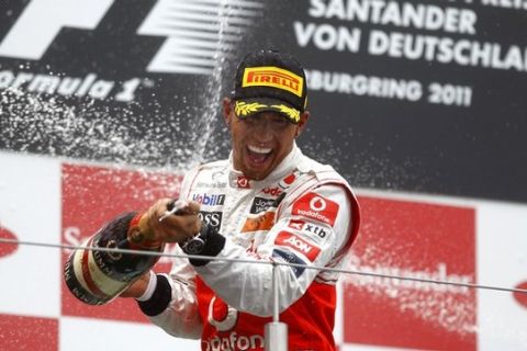 McLaren Formula One driver Lewis Hamilton of Britain celebrates after winning the German F1 Grand Prix at the Nuerburgring circuit July 24, 2011. Hamilton won the race ahead of Ferrari's Fernando Alonso of Spain Red Bull's Mark Webber of Australia.  REUTERS/Kai Pfaffenbach (GERMANY - Tags: SPORT MOTOR RACING)