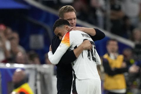 Germany's head coach Julian Nagelsmann embraces Germany's Jamal Musiala during a Group A match between Germany and Scotland at the Euro 2024 soccer tournament in Munich, Germany, Friday, June 14, 2024. (AP Photo/Frank Augstein)