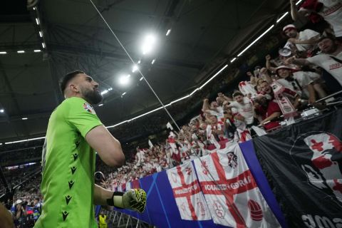 Georgia's goalkeeper Giorgi Mamardashvili celebrates at the end of a Group F match between Georgia and Portugal at the Euro 2024 soccer tournament in Gelsenkirchen, Germany, Wednesday, June 26, 2024. (AP Photo/Alessandra Tarantino)