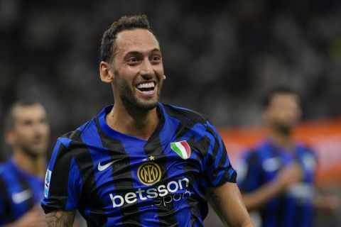 Inter Milan's Hakan Calhanoglu celebrates after scoring his side's second goal during a Serie A soccer match between Inter Milan and Lecce, at the San Siro stadium in Milan, Italy, Saturday, Aug. 24, 2024. (AP Photo/Luca Bruno)