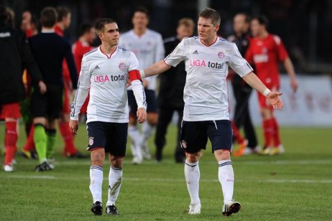 RESTRICTIONS / EMBARGO - ONLINE CLIENTS MAY USE UP TO SIX IMAGES DURING EACH MATCH WITHOUT THE AUTHORISATION OF THE DFL. NO MOBILE USE DURING THE MATCH AND FOR A FURTHER TWO HOURS AFTERWARDS IS PERMITTED WITHOUT THE AUTHORISATION OF THE DFL.Munich's midfielder Bastian Schweinsteiger (R) and defender Philipp Lahm leave the pitch after the German first division Bundesliga football match 1. FC Cologne vs FC Bayern Munich in the western German city of Cologne on February 5, 2011. Cologne won the match 3-2.      AFP PHOTO / PATRIK STOLLARZ (Photo credit should read PATRIK STOLLARZ/AFP/Getty Images)