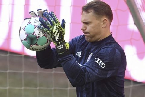 Bayern Munich's goalkeeper Manuel Neuer warms up before the German Bundesliga soccer match between Bayern Munich and FC Union Berlin at Allianz Arena in Munich, Germany, Saturday, April 10, 2021.(Andreas Gebert/Pool via AP)