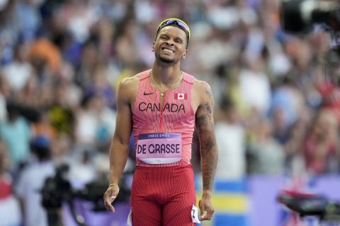 Andre de Grasse, of Canada, reacts after crossing the finish line in a men's 200 meters round 1 heat at the 2024 Summer Olympics, Monday, Aug. 5, 2024, in Saint-Denis, France. (AP Photo/Ashley Landis)