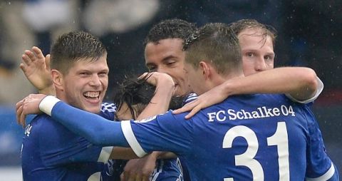 Schalke's Klaas-Jan Huntelaar of the Netherlands, left, celebrates after scoring his side's second goal during the German first division Bundesliga soccer match between FC Schalke 04 and Borussia Dortmund in Gelsenkirchen, Germany, Saturday, March 9, 2013. (AP Photo/Martin Meissner)