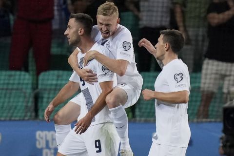 Slovenia's Andraz Sporar, left, celebrates with his teammates after scoring against Denmark during the Euro 2024 group H qualifying soccer match between Slovenia and Denmark at Stozice stadium in Ljubljana, Slovenia, Monday, June 19, 2023. (AP Photo/Darko Bandic)