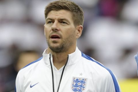 England captain Steven Gerrard stands in a team line up during the playing of the national anthems before the international friendly soccer match between England and Peru at Wembley Stadium in London, Friday, May 30, 2014.  (AP Photo/Matt Dunham)

