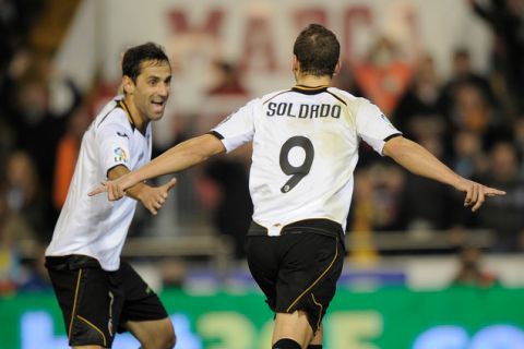 Valencia's forward Roberto Soldado  (R) celebrates with teammate Valencia's Brazilian midfielder Jonas (L) after scoring during the Spanish Cup KIng football match Valencia CF vs Levante  on January 19, 2012 at the Mestalla stadium in Valencia.AFP PHOTO/ JOSE JORDAN (Photo credit should read JOSE JORDAN/AFP/Getty Images)