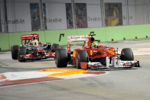 Ferrari driver Felipe Massa (front R) of Brazil and McLaren-Mercedes driver Lewis Hamilton (back L) of Britain take a bend during the Formula One Singapore Grand Prix in Singapore on September 25, 2011. AFP PHOTO / ROSLAN RAHMAN (Photo credit should read ROSLAN RAHMAN/AFP/Getty Images)