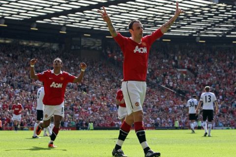 Manchester United's Bulgarian striker Dimitar Berbatov (R) celebrates scoring the opening goal of the English Premier League football match between Manchester United and Fulham at Old Trafford in Manchester, north-west England on April 9, 2011. AFP PHOTO/ADRIAN DENNISFOR EDITORIAL USE ONLY Additional licence required for any commercial/promotional use or use on TV or internet (except identical online version of newspaper) of Premier League/Football League photos. Tel DataCo +44 207 2981656. Do not alter/modify photo. (Photo credit should read ADRIAN DENNIS/AFP/Getty Images)