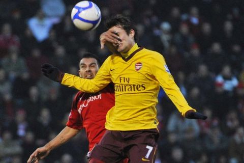 Leyton Orient's Jason Crowe (L) and Arsenal's Tomas Rosicky fight for the ball during their FA Cup soccer match at Matchroom Stadium in London February 20, 2011. REUTERS/Toby Melville (BRITAIN - Tags: SPORT SOCCER)