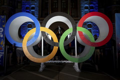 Olympic rings are pictured Wednesday, July 24, 2024, in Salt Lake City, while people gather to watch a live stream from Paris as the International Olympic Committee awards Salt Lake City the 2034 Winter Olympics. (AP Photo/Spenser Heaps)