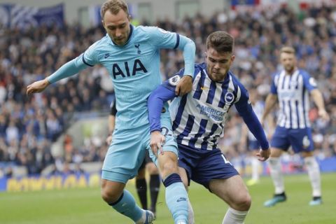 Brighton's Aaron Connolly, right, challenges for the ball with Tottenham's Christian Eriksen during the English Premier League soccer match between Brighton and Hove Albion and Tottenham Hotspur at Falmer stadium in Brighton, England Saturday, Oct. 5, 2019. (AP Photo/Kirsty Wigglesworth)