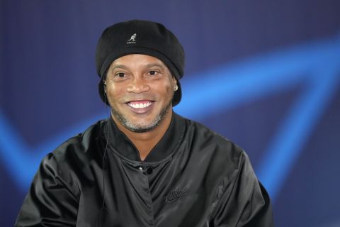 Former Brazil and PSG soccer legend Ronaldinho smiles as he answers a reporters question before the Champions League group A soccer match between Paris Saint Germain and RB Leipzig at the Parc des Princes stadium in Paris, Tuesday, Oct. 19, 2021. Ronaldinho is scheduled to do a lap of honor before that match starts. (AP Photo/Francois Mori)