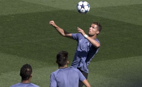 Real Madrid's Cristiano Ronaldo jumps to head a ball during a training session in Madrid, Tuesday, May 9, 2017. Real Madrid will play against Atletico Madrid on Wednesday in a Champions League semifinal, 2nd leg soccer match. (AP Photo/Paul White)