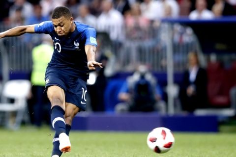 France's Kylian Mbappe scores his side's fourth goal during the final match between France and Croatia at the 2018 soccer World Cup in the Luzhniki Stadium in Moscow, Russia, Sunday, July 15, 2018. (AP Photo/Petr David Josek)