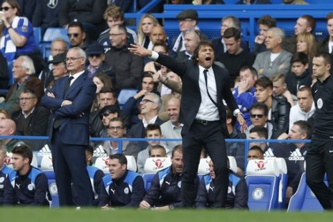 Chelsea's manager Antonio Conte, centre, gestures towards his players as Leicester City's manager Claudio Ranieri, left, looks on during the English Premier League soccer match between Chelsea and Leicester City, at Stamford Bridge stadium in London, Saturday, Oct. 15, 2016. (AP Photo/Alastair Grant)