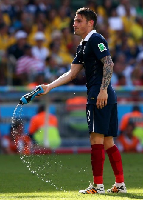 RIO DE JANEIRO, BRAZIL - JULY 04: Mathieu Debuchy of France throws a water bottle during the 2014 FIFA World Cup Brazil Quarter Final match between France and Germany at Maracana on July 4, 2014 in Rio de Janeiro, Brazil.  (Photo by Jamie Squire/Getty Images)