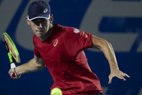 Australia's Alex de Minaur returns the ball in his Round 1 match against Serbia's Miomir Kecmanovic, at the Mexican Tennis Open in Acapulco, Mexico, Monday, Feb. 24, 2020. (AP Photo/Rebecca Blackwell)