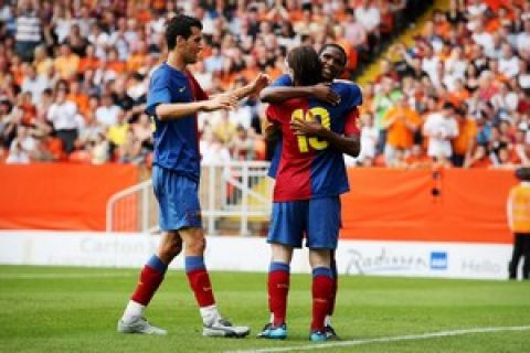 Barcelona's Lionel Messi (c) and Samuel Eto'o embrace (R) following Eto's goal against Dundee United as teammate Victor Vasquez walks in during a friendly football match at Tannadice Stadium in Dundee, Scotland on July 26, 2008. AFP Photo/Ed Jones  (Photo credit should read ED Jones/AFP/Getty Images)