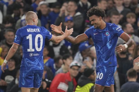 Chelsea's Renato Veiga, right, celebrates with Mykhailo Mudryk after scoring the opening goal during the Europa Conference League opening phase soccer match between Chelsea and Gent at Stamford Bridge in London, Thursday, Oct. 3, 2024. (AP Photo/Kin Cheung)