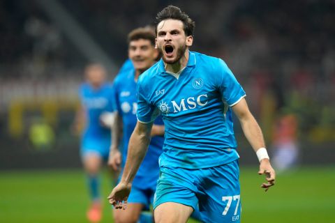 Napoli's Khvicha Kvaratskhelia, centre, celebrates after scoring his side's second goal during the Serie A soccer match between AC Milan and Napoli at the San Siro stadium, in Milan, Italy, Tuesday, Oct. 29, 2024. (AP Photo/Luca Bruno)