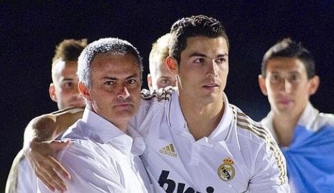 Real Madrid's Portuguese forward Cristiano Ronaldo (R) and Real Madrid's Portuguese coach Jose Mourinho celebrate winning Spanish League title on May 13, 2012 at the Santiago Bernabeu stadium in Madrid. The Santiago Bernabeu was given the first chance to celebrate Real Madrid's Portuguese coach Jose Mourinho's first Spanish title with 'los blancos' and resonated with a celebratory atmosphere to see skipper Iker Casillas lift the trophy after the match. AFP PHOTO/ Jaime REINA
