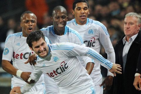 Marseille's forward Andre-Pierre Gignac (front) is congratulated by teammates after he scored a goal during the French L1 football match Marseille versus Bordeaux on January 16, 2011 at the Velodrome stadium in Marseille, southern France.  AFP PHOTO / GERARD JULIEN (Photo credit should read GERARD JULIEN/AFP/Getty Images)