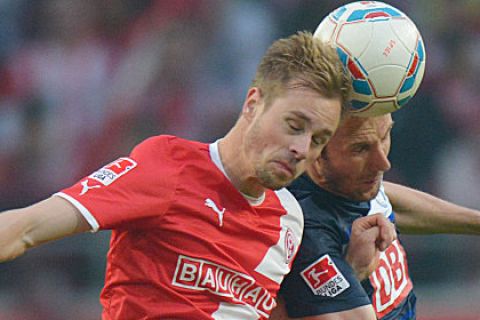 DUESSELDORF, GERMANY - MAY 15: Andreas Lambertz (L) of Duesseldorf and Roman Hubnik of Berlin heqad for the ball during the Bundesliga Relegation match between Fortuna Duesseldorf and Hertha BSC Berlin at Esprit-Arena on May 15, 2012 in Duesseldorf, Germany.  (Photo by Thomas Starke/Bongarts/Getty Images)