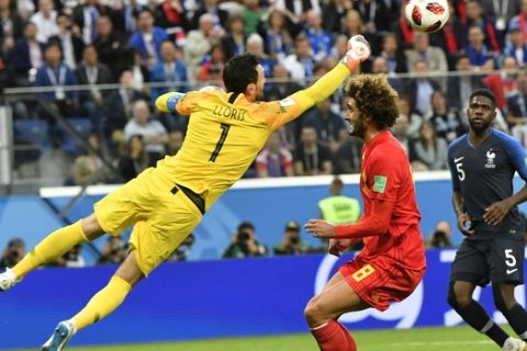 France goalkeeper Hugo Lloris, left, deflects a ball ahead of Belgium's Marouane Fellaini during the semifinal match between France and Belgium at the 2018 soccer World Cup in the St. Petersburg Stadium in St. Petersburg, Russia, Tuesday, July 10, 2018. (AP Photo/Martin Meissner)