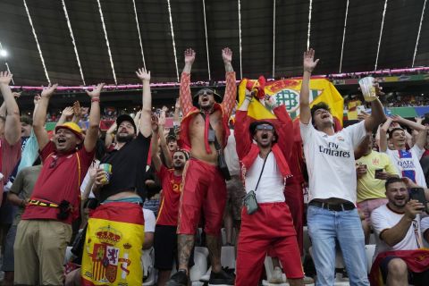 Spain fans cheer on the stands while waiting for the start of a semifinal match between Spain and France at the Euro 2024 soccer tournament in Munich, Germany, Tuesday, July 9, 2024. (AP Photo/Matthias Schrader)