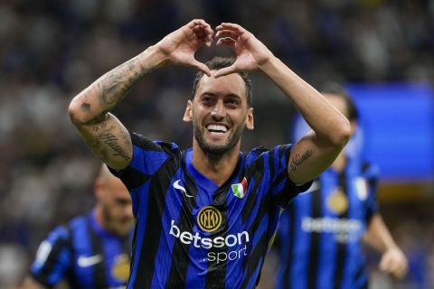 Inter Milan's Hakan Calhanoglu celebrates after scoring his side's second goal during a Serie A soccer match between Inter Milan and Lecce, at the San Siro stadium in Milan, Italy, Saturday, Aug. 24, 2024. (AP Photo/Luca Bruno)