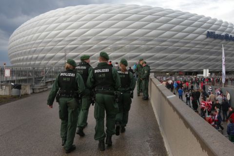 Police officers guard outside the "Allianz Arena" soccer stadium prior to the German Soccer Cup (DFB Pokal) semi final soccer match between FC Bayern Munich and VfL Wolfsburg, in Munich, southern Germany, Tuesday, April 16, 2013. (AP Photo/Matthias Schrader)