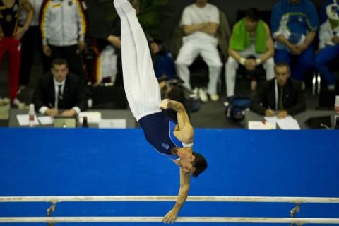 Greece's Vasileios Tsolakidis (bronze) performs to place third in the men's apparatus finals on the parallel bars during the 4th European Artistic Gymnastics Championships in Berlin April 10, 2011. AFP PHOTO / JOHN MACDOUGALL (Photo credit should read JOHN MACDOUGALL/AFP/Getty Images)