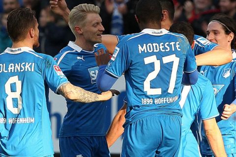 Hoffenheim's players celebrate during the German first division Bundesliga football match TSG 1899 Hoffenheim vs VfL Wolfsburg in Sinsheim, Germany, on March 2, 2014. AFP PHOTO / DANIEL ROLAND

DFL RULES TO LIMIT THE ONLINE USAGE DURING MATCH TIME TO 15 PICTURES PER MATCH. FOR FURTHER QUERIES PLEASE CONTACT DFL DIRECTLY AT + 49 69 650050.        (Photo credit should read DANIEL ROLAND/AFP/Getty Images)