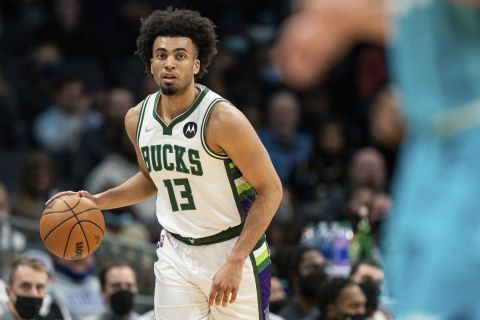 Milwaukee Bucks forward Jordan Nwora (13) brings the ball upcourt against the Charlotte Hornets during the first half of an NBA basketball game in Charlotte, N.C., Monday, Jan. 10, 2022. (AP Photo/Jacob Kupferman)