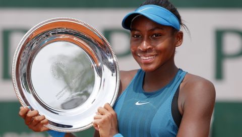 Cori Gauff of the U.S, shows her trophy after defeating her compatriot Caty McNally in girls' singles final match of the French Open tennis tournament at the Roland Garros stadium, Saturday, June 9, 2018 in Paris. Gauff won 1-6, 6-3, 7-6. (AP Photo/Thibault Camus)